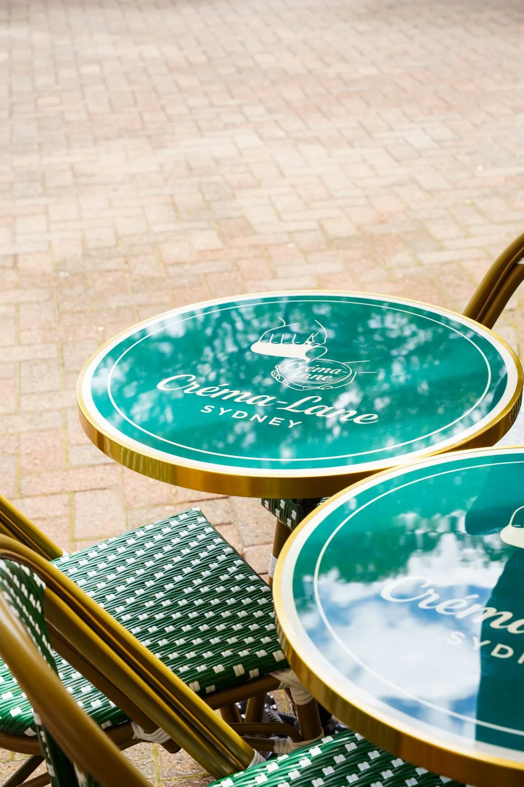 Custom Créma-Lane bistro tables and woven chairs
