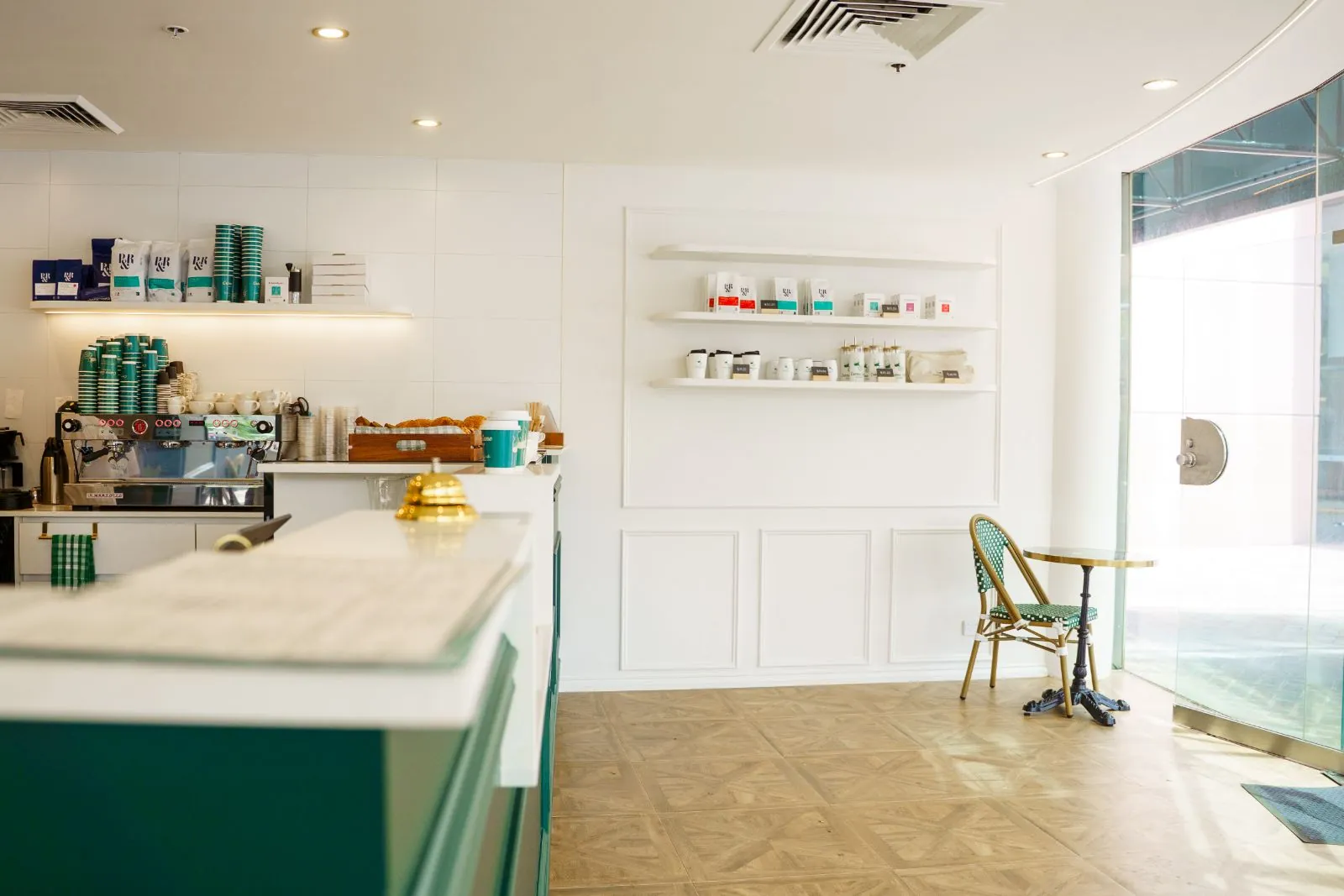 Créma-Lane interior with floating shelves and bistro seating